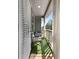 Inviting covered balcony with cozy seating and artificial turf for a touch of outdoor comfort at 137 White Mountain Pass, Mcdonough, GA 30252