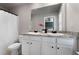 Bright bathroom featuring a double vanity with a granite countertop and white cabinets at 137 White Mountain Pass, Mcdonough, GA 30252