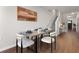 This dining room features hardwood floors, a modern table set for six, and neutral wall decor at 137 White Mountain Pass, Mcdonough, GA 30252