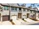Street view of attractive townhomes with brick facades, attached garages, and well-kept landscaping at 137 White Mountain Pass, Mcdonough, GA 30252