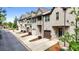 Street view of well-maintained townhomes featuring brick facades, garages, and manicured landscaping at 137 White Mountain Pass, Mcdonough, GA 30252