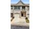 Charming townhome featuring gray and brick exterior, garage, balcony, and landscaped front at 137 White Mountain Pass, Mcdonough, GA 30252