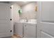 Bright laundry room featuring a side-by-side washer and dryer, and overhead shelving at 137 White Mountain Pass, Mcdonough, GA 30252