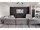 Comfortable living room featuring a large sofa, ceiling fan and a decorative wall at 137 White Mountain Pass, Mcdonough, GA 30252