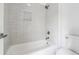 Clean bathroom features a white bathtub, shower, and sleek white tile surround and fixtures at 2160 Waters Ferry Dr, Lawrenceville, GA 30043