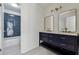 Bathroom showcasing double sinks, a blue vanity, and a shower with sleek, modern tile work at 2160 Waters Ferry Dr, Lawrenceville, GA 30043