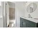 Stylish bathroom with modern vanity, elegant fixtures, and a glimpse of a bathtub-shower with decorative tile at 2160 Waters Ferry Dr, Lawrenceville, GA 30043