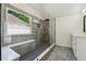 Bathroom showcasing a tiled walk-in shower, a bench, and a window at 2160 Waters Ferry Dr, Lawrenceville, GA 30043