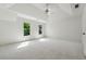 Spacious bedroom with two windows, white carpet, white walls, and a ceiling fan at 2160 Waters Ferry Dr, Lawrenceville, GA 30043