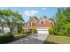 Charming brick two-story home featuring a manicured lawn, mature trees and an attached two-car garage at 2160 Waters Ferry Dr, Lawrenceville, GA 30043