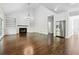 Spacious living room with hardwood floors, fireplace, custom built-ins, and stainless steel refrigerator at 2160 Waters Ferry Dr, Lawrenceville, GA 30043