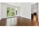 Spacious living room featuring hardwood floors and large windows providing natural light with forest view at 2160 Waters Ferry Dr, Lawrenceville, GA 30043