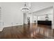 Spacious open-concept living room featuring hardwood floors, a fireplace, and adjacent gourmet kitchen at 2160 Waters Ferry Dr, Lawrenceville, GA 30043
