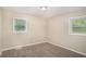 Neutral bedroom featuring two windows with natural light and plush carpeting at 310 Oak Se Dr, Atlanta, GA 30354