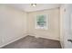 Bedroom with two windows featuring neutral colored walls and carpet flooring at 310 Oak Se Dr, Atlanta, GA 30354