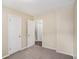 Bedroom with three doors showcasing neutral colored walls and carpet flooring at 310 Oak Se Dr, Atlanta, GA 30354
