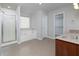 Bright bathroom with a tiled floor, shower, soaking tub, and a large window at 415 Village Way, Woodstock, GA 30188