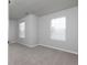 Neutral bedroom featuring two bright windows and neutral carpet flooring at 415 Village Way, Woodstock, GA 30188