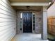 Covered front entrance with a dark front door, stone detailing and traditional sidelights at 415 Village Way, Woodstock, GA 30188