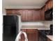 Functional kitchen with wood cabinets, laminate counters, and modern black appliances at 415 Village Way, Woodstock, GA 30188