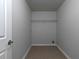 Small laundry room with tile floors and gray walls at 415 Village Way, Woodstock, GA 30188