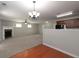Spacious living room with a fireplace, plush carpet, and an open view to the kitchen at 415 Village Way, Woodstock, GA 30188