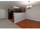 Open-concept living area featuring hardwood floors, neutral walls, and a view to the kitchen at 415 Village Way, Woodstock, GA 30188