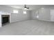 Large living room with neutral walls and flooring, a fireplace, and doorways to other rooms at 415 Village Way, Woodstock, GA 30188
