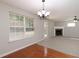 Bright living area with large windows, fireplace, and access to the backyard at 415 Village Way, Woodstock, GA 30188