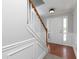 Bright stairway with white spindles, wood railing, and freshly painted white walls at 415 Village Way, Woodstock, GA 30188