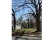 Sunny lot with large trees and partial grass cover, ready for new construction at 419 Lanier Nw St, Atlanta, GA 30318