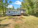 Backyard features a wooden deck, screened in porch and lush greenery at 4357 Treeline Way, Douglasville, GA 30135