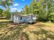 Home with a backyard featuring a deck, and lush mature trees at 4357 Treeline Way, Douglasville, GA 30135