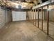 Unfinished basement, with unfinished drywall, utility connections, and garage door at 4357 Treeline Way, Douglasville, GA 30135