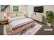 Comfortable staged bedroom with a bed, nightstands, dresser, TV and soft rug at 4357 Treeline Way, Douglasville, GA 30135