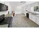 Bright kitchen with white cabinets, granite countertops, stainless appliances, and stylish flooring at 4357 Treeline Way, Douglasville, GA 30135