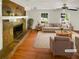 Bright, staged living room with a stone fireplace, hardwood floors, and neutral furniture at 4357 Treeline Way, Douglasville, GA 30135