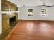 Spacious living room with hardwood floors, a stone fireplace, and natural light from windows at 4357 Treeline Way, Douglasville, GA 30135