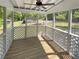 Screened porch with wood-look flooring, white lattice surround, and ceiling fan overlooking a wooded lot at 4357 Treeline Way, Douglasville, GA 30135