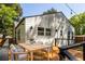 Back deck showcasing a dining set, overhead string lights, and the house's exterior at 1481 Almont Sw Dr, Atlanta, GA 30310