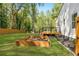 Wide backyard featuring a garden box, green grass, privacy fence and deck with seating at 1481 Almont Sw Dr, Atlanta, GA 30310