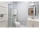 The bathroom features a shower with glass doors, toilet, storage cabinet, and vanity at 1481 Almont Sw Dr, Atlanta, GA 30310