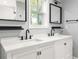 Modern bathroom with double sink vanity, sleek black fixtures, and window for natural light at 1481 Almont Sw Dr, Atlanta, GA 30310