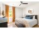 Cozy bedroom with neutral walls, wood floors, warm curtains, and a comfortable bed at 1481 Almont Sw Dr, Atlanta, GA 30310