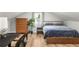 Cozy bedroom featuring a bed, dresser, desk, wood flooring, and sloped ceilings at 1481 Almont Sw Dr, Atlanta, GA 30310