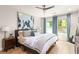 Spacious bedroom with large windows, ceiling fan, and decor at 1481 Almont Sw Dr, Atlanta, GA 30310