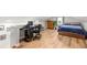 Spacious bedroom area with a bed, desk, dresser, wood floors, and an office space at 1481 Almont Sw Dr, Atlanta, GA 30310