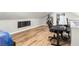 Lofted bonus room with hardwood floors, desk, shelving, and modern decor at 1481 Almont Sw Dr, Atlanta, GA 30310
