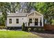 Charming home featuring a covered front porch, manicured landscaping and a newly painted exterior at 1481 Almont Sw Dr, Atlanta, GA 30310