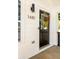 Modern black front door featuring updated hardware and decorative wreath with natural lighting at 1481 Almont Sw Dr, Atlanta, GA 30310